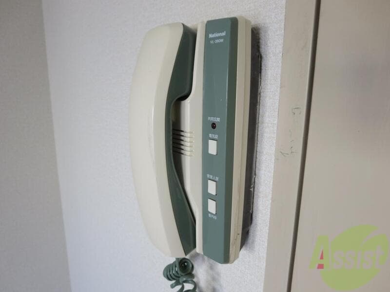 Wall-mounted apartment intercom handset — home connectivity and telecom sign-up handled by AKI HOME